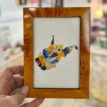 Load image into Gallery viewer, Medium lacquered wood framed cutout of West Virginia with gold leaf and pink, yellow, and navy paint chips from artist Emily Kurth's palette.