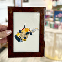 Load image into Gallery viewer, Dark lacquered wood framed cutout of West Virginia with gold leaf and yellow, light blue, pink, and navy paint chips from artist Emily Kurth's palette.
