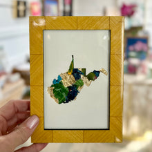 Load image into Gallery viewer, Medium lacquered wood framed cutout of West Virginia with gold leaf and green, turquoise, yellow, and navy paint chips from artist Emily Kurth's palette.