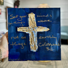 Load image into Gallery viewer, Painting of a textured gold leaf cross on a dark blue background by artist Emily Kurth.  Scripture written on background, Set your minds on things above, not on earthly things. Colossians 3:2