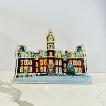 Load image into Gallery viewer, Acrylic cutout of the West Virginia University building, Woodburn Hall with Christmas lights against a white background.  Original artwork by artist Emily Kurth.