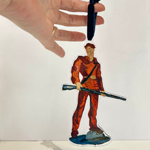 Load image into Gallery viewer, Acrylic ornament of the West Virginia University mascot, the Mountaineer holding his musket against a white background.  Original artwork by artist Emily Kurth.