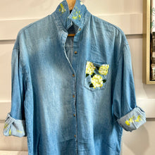 Load image into Gallery viewer, Blue denim shirt with floral painting on a neutral background