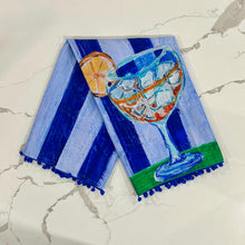 Load image into Gallery viewer, Decorative tea towel with iced tea on royal and light blue striped background on marble surface.