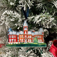 Load image into Gallery viewer, Acrylic ornament of the West Virginia University building, Woodburn Hall  against a Christmas tree background.  Original artwork by artist Emily Kurth.