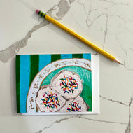 Greeting card with colorful sprinkle cookies on a plate with a blue and green striped background.