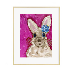 Load image into Gallery viewer, A painting featuring a beige bunny with a blue hydrangea on its head, set against a fuchsia background, presented in a gold frame.