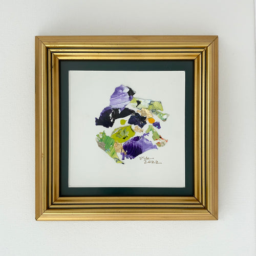 Purple, green, and yellow paint chips in abstract art. Brushed gold frame. 7.75