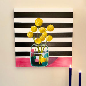 24" x 24" acrylic on canvas. Vase of yellow billy button flowers on pink table on black and white horizontal stripe background by West Virginia artist Emily Kurth.