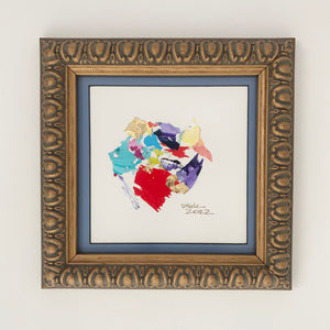 Purple, red, yellow, turquoise, and yellow paint chips in abstract art. Brushed gold frame. 8.25