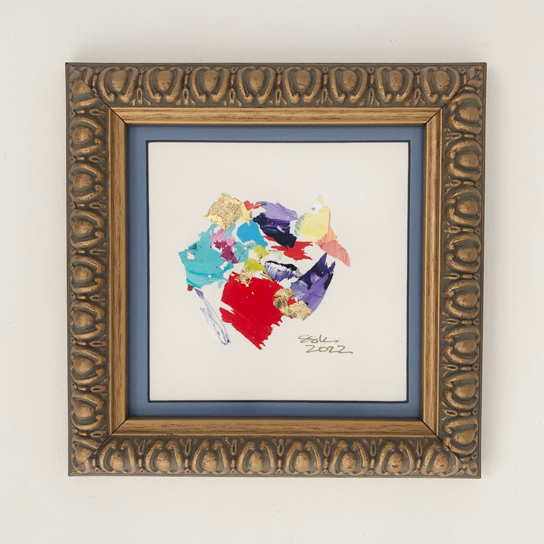 Purple, red, yellow, turquoise, and yellow paint chips in abstract art. Brushed gold frame. 8.25