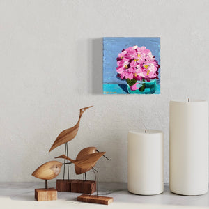 pink hydrangea on light blue background in vase by artist Emily Kurth