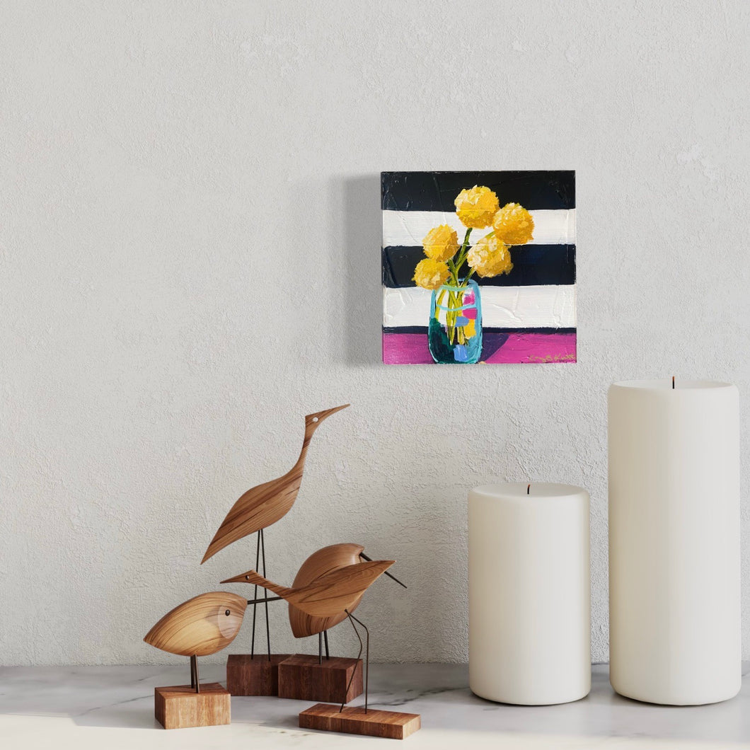 Yellow billy button flowers on navy and white striped background in vase by artist Emily Kurth